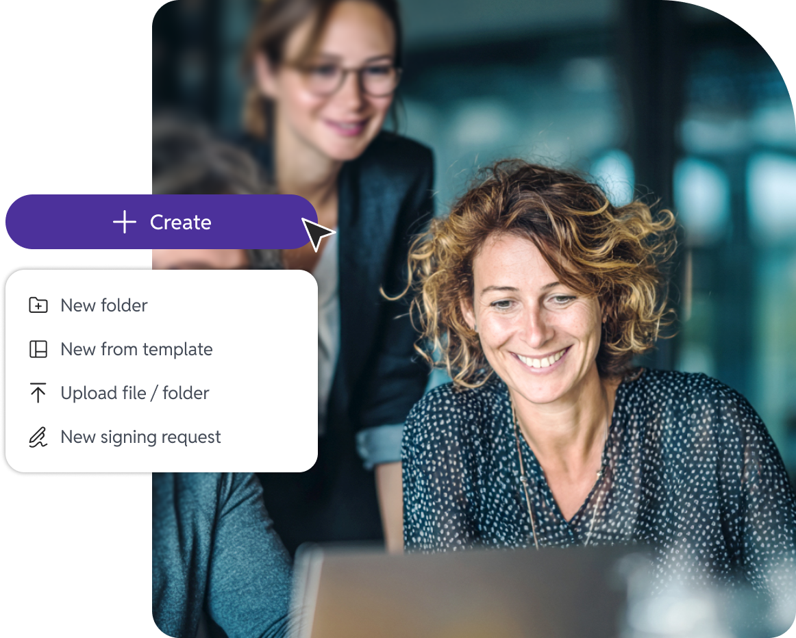 Image of a group of people looking at a laptop