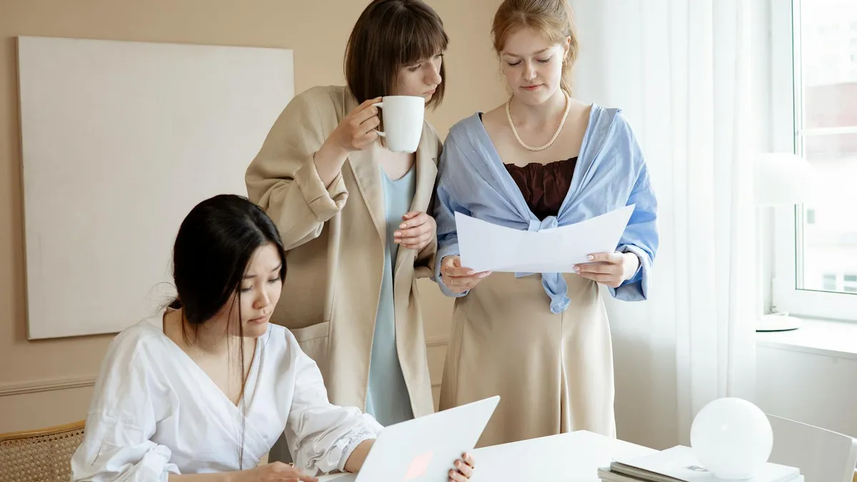 Professional services team reviewing documents on a laptop using document control software