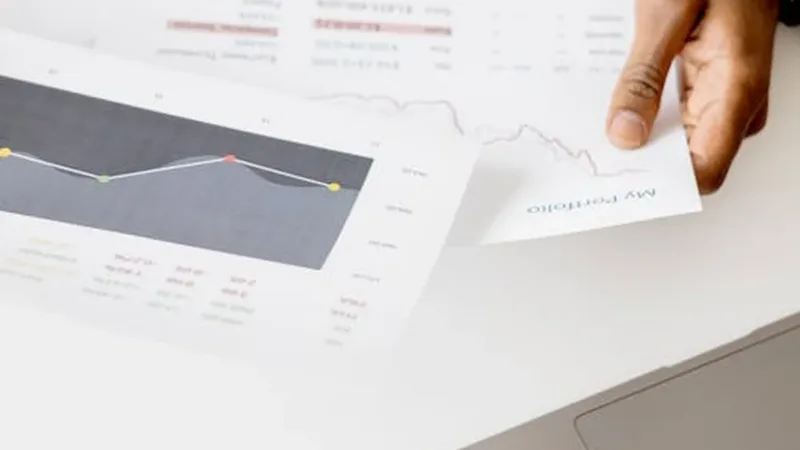 Laptop displaying accounting workflow charts and reports on a business desk