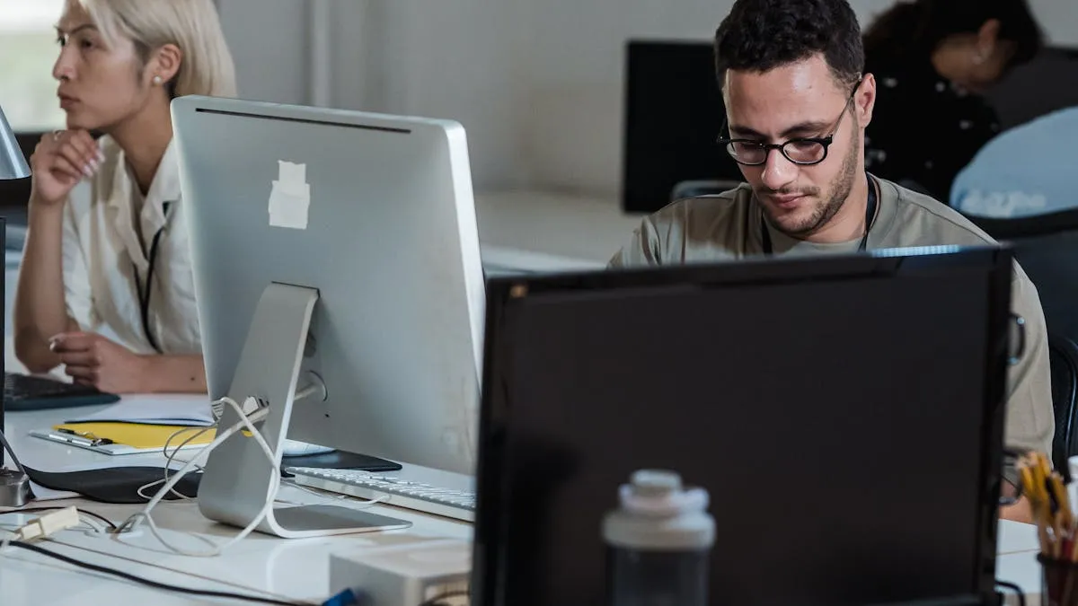 Team members working on computers managing documents in an office